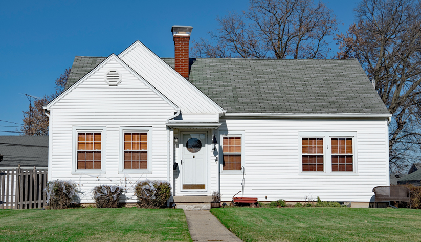 exterior view of a ranch style home painted white