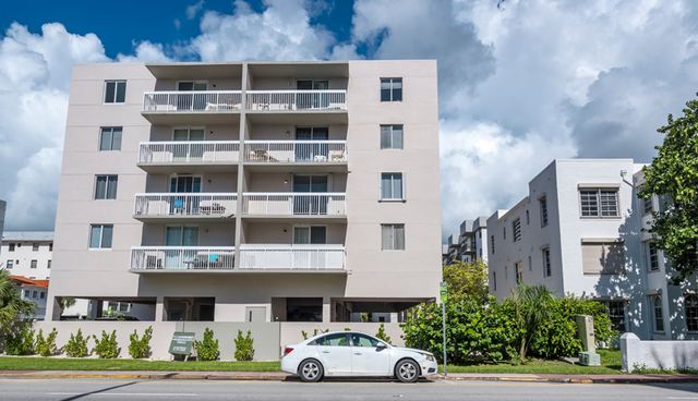 Exterior of white four story condominium building