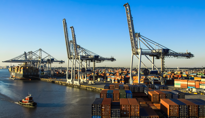 A port full of shipping containers and loading cranes