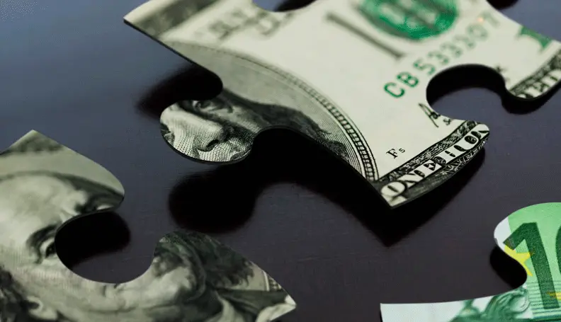 puzzle pieces, not quite joined, in the form of dollar bill
