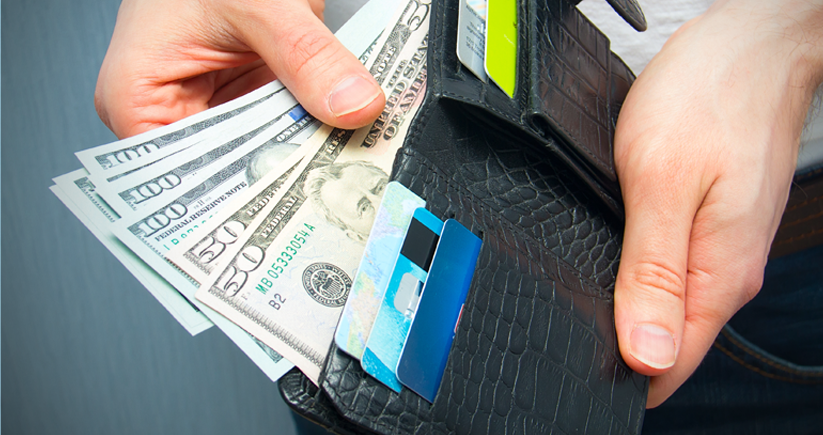 man holding wallet with credit cards and cash