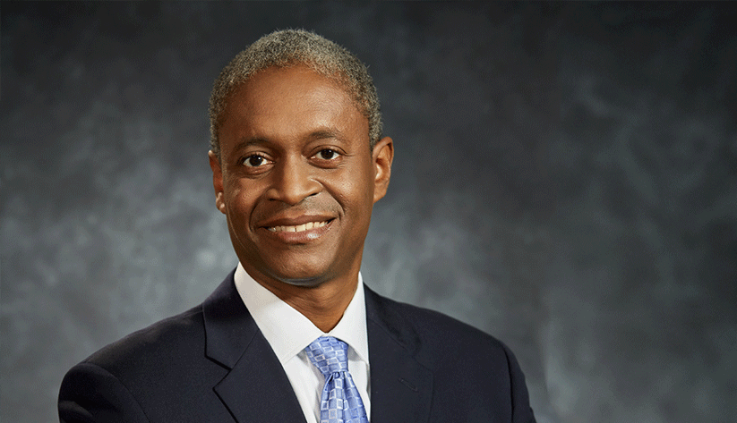 Raphael Bostic: portrait in front of marbled grey background.