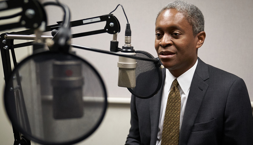 Photo of Raphael Bostic speaking into interview microphone