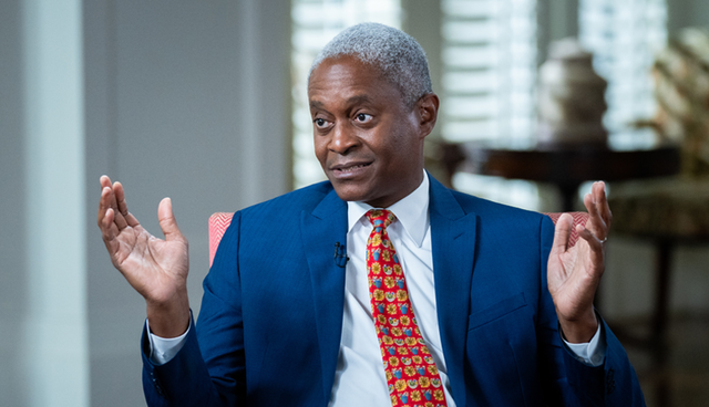 Raphael Bostic using arm gestures during discussion