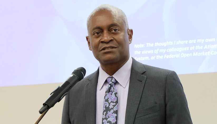 Raphael Bostic speaking into a microphone