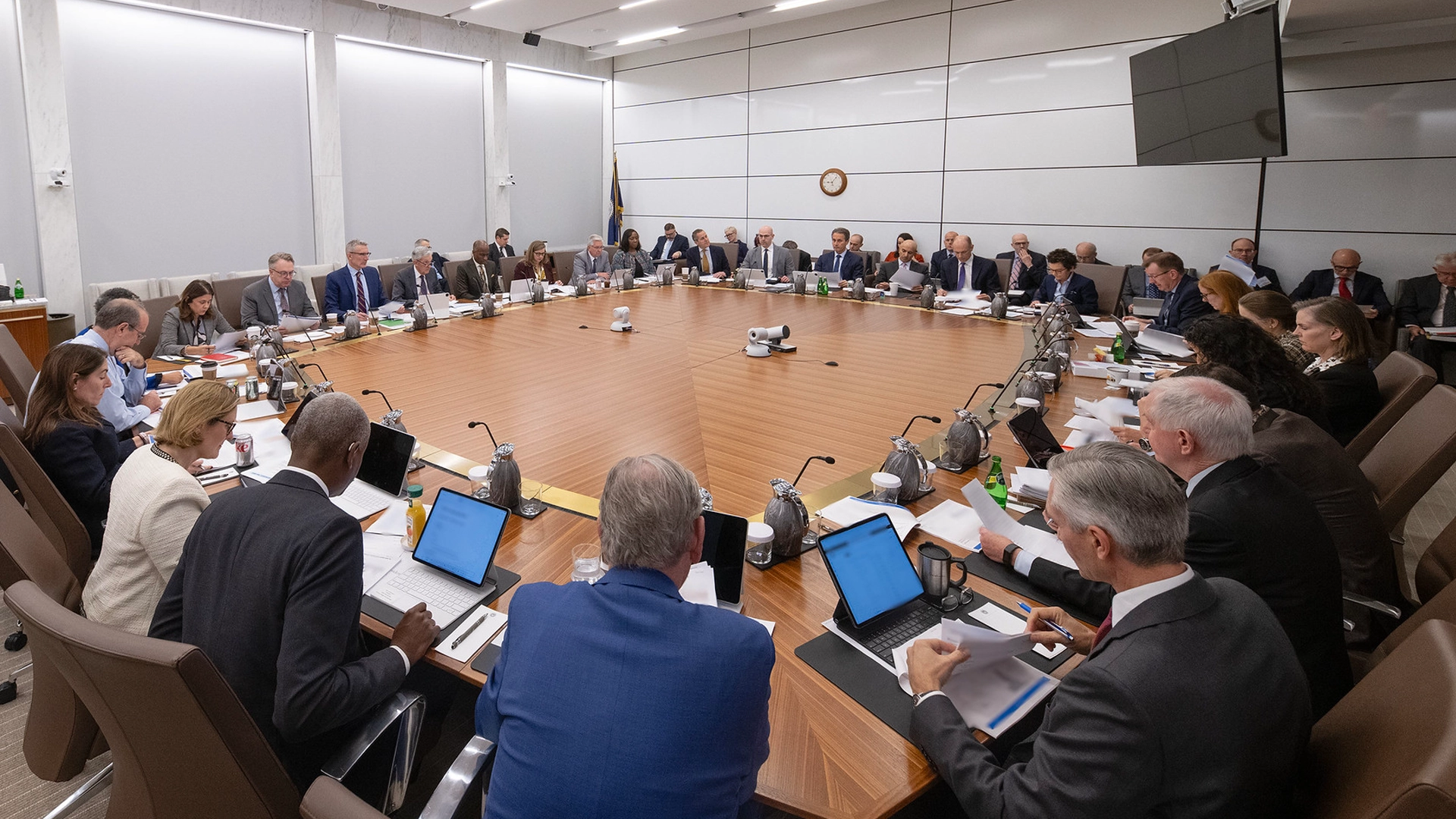 photograph of fomc meeting taking place around a square table