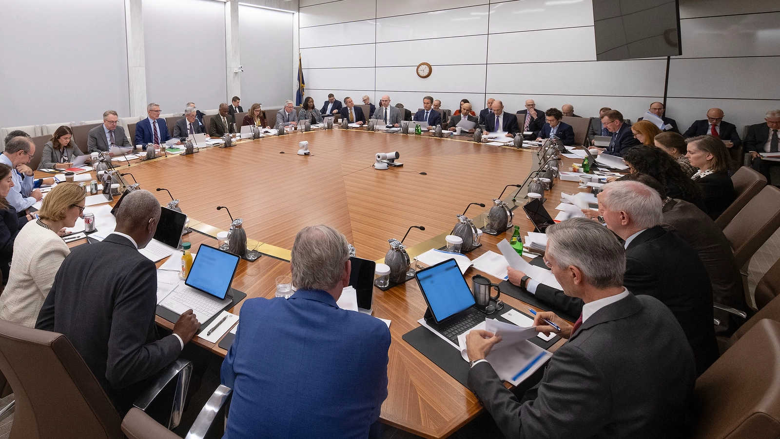 photograph of fomc meeting taking place around a square table