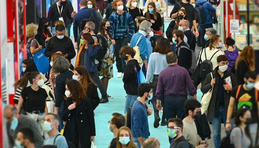 people in masks at the airport crowd