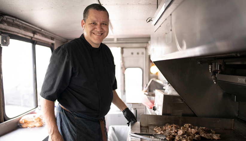 Oscar Mendivil cooking on a restaurant grill