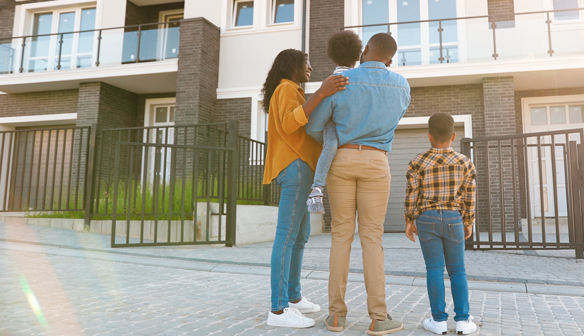 family of four facing away looking at town homes