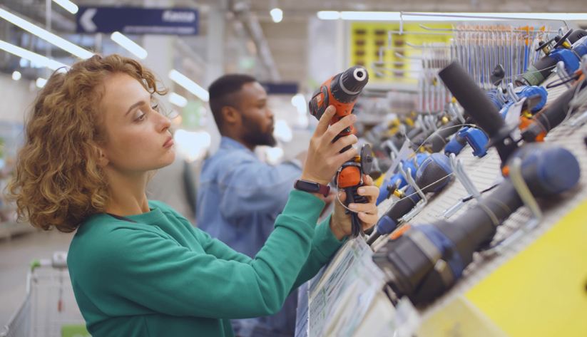 Person holding power tool inside store