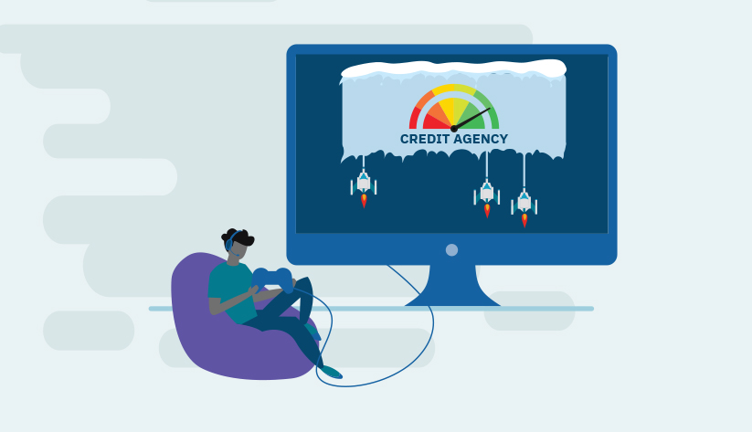 person sitting on bean bag chair gaming in front of monitor with credit agency on the screen