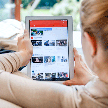 Photo of a woman looking at a Youtube playlist