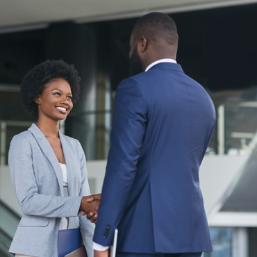 two people in business suits shaking hands