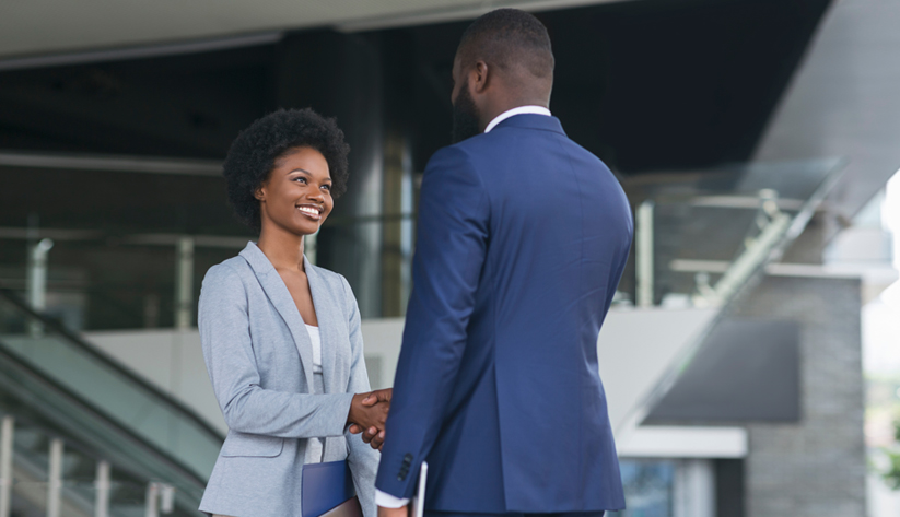 two people in business suits shaking hands