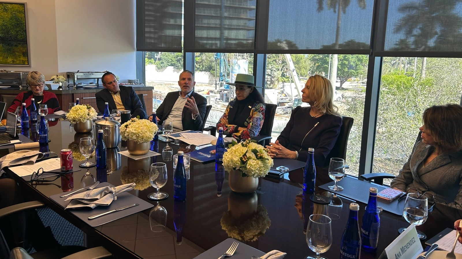 A listening session held at the Atlanta Fed's Miami Branch with branch directors sitting around a board room table.