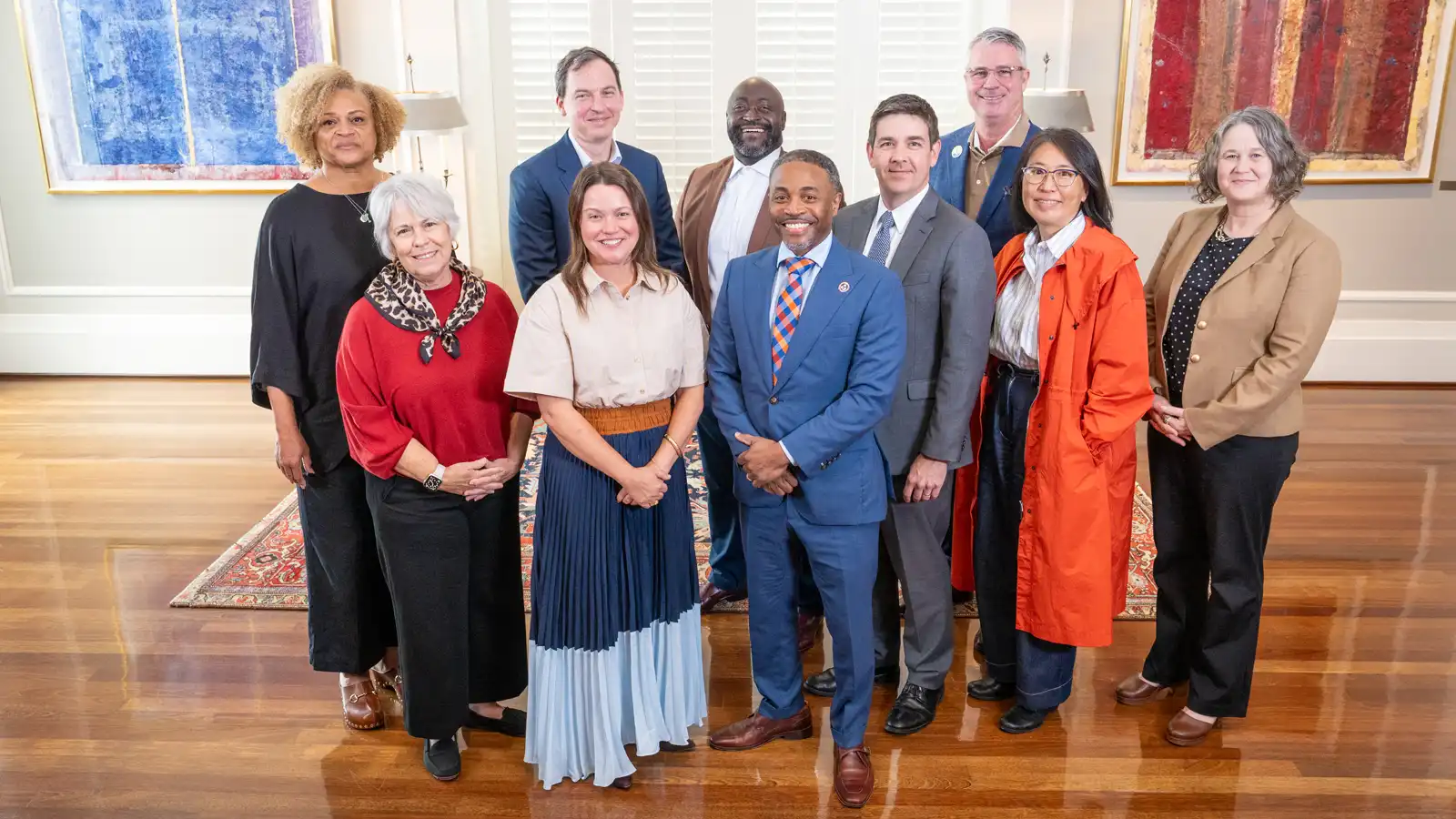The ten members of the Community Advisory Council pose together for a formal group photo indoors.
