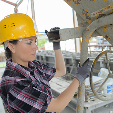 female worker with a hard hat on at the job