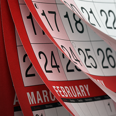 a calendar with its pages blowing through several months of pages