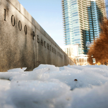 View from a snow-filled sidewalk toward the marble panel engraved with the bank's street address