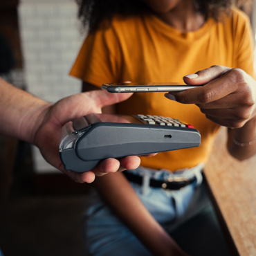 casual handing of payment card to another person holding portable card reader
