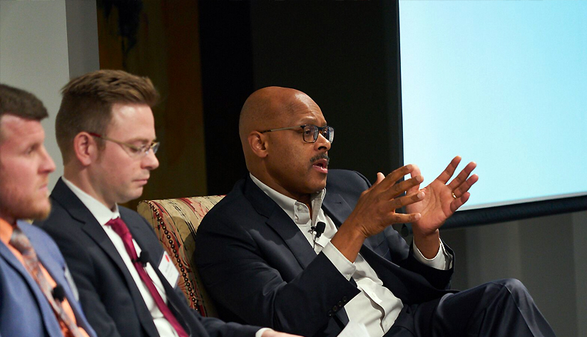 Photo of three men in a panel discussion